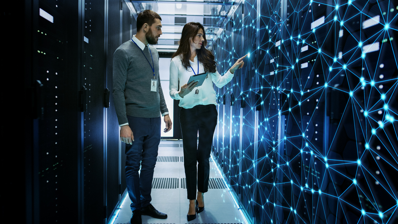 IT Engineers Discussing Technical Details in a Working Data Center/ Server Room with Internet Connection Visualization, hoosing the Right IT Infrastructure for Your Business