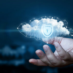 Hand shows a data cloud with a protective shield. The concept of data protection